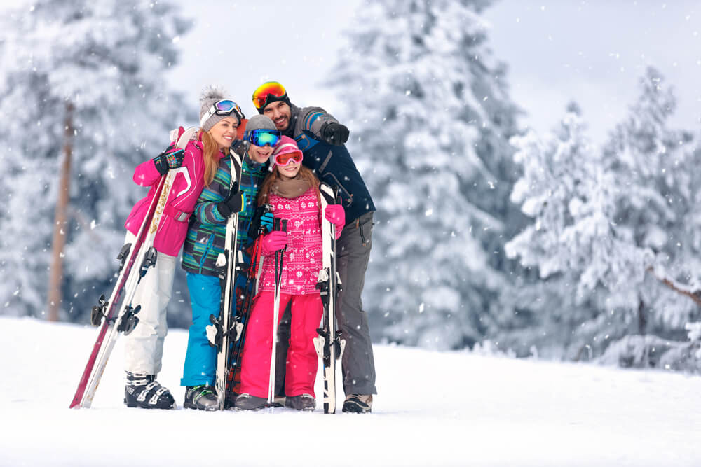 Family posing for a photo during a winter getaway at the Sapphire Valley ski area