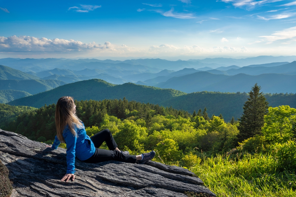 Person sitting at overlook on hiking trail in Cashiers NC